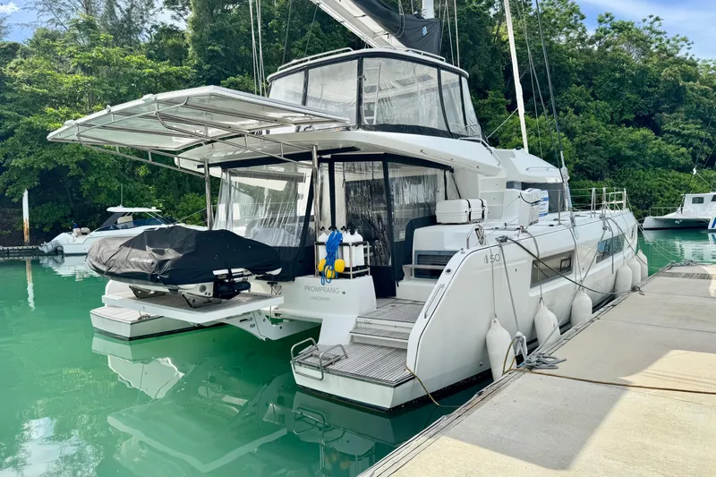 Promprang Yacht Photos Pics 2020 Lagoon 50 catamaran docked in a serene marina setting.