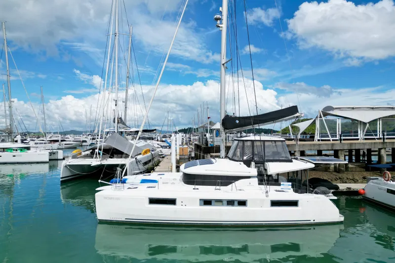 Promprang Yacht Photos Pics 2020 Lagoon 50 catamaran docked at marina under blue sky.
