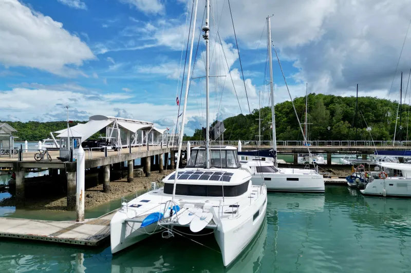 Promprang Yacht Photos Pics 2020 Lagoon 50 catamaran docked at marina under blue sky.