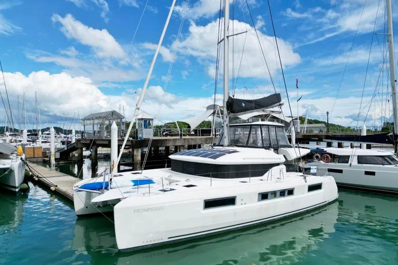 Promprang Yacht Photos Pics 2020 Lagoon 50 catamaran docked at marina under blue sky.