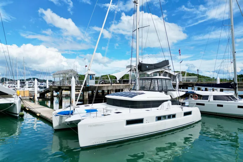 Promprang Yacht Photos Pics 2020 Lagoon 50 catamaran docked at marina under blue sky.