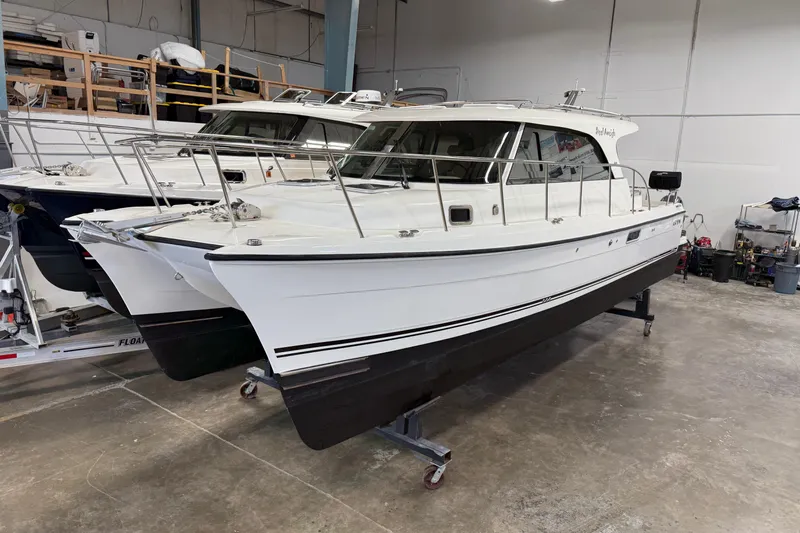  Yacht Photos Pics 2021 Aspen C108 catamaran in a storage facility, showcasing sleek design and modern features.