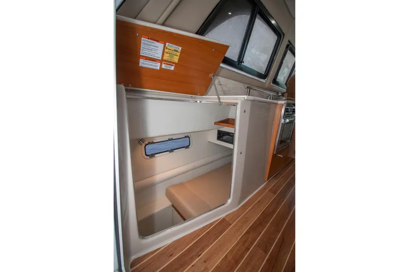  Yacht Photos Pics 2021 Aspen C108 interior with open storage, wooden flooring, and windows.