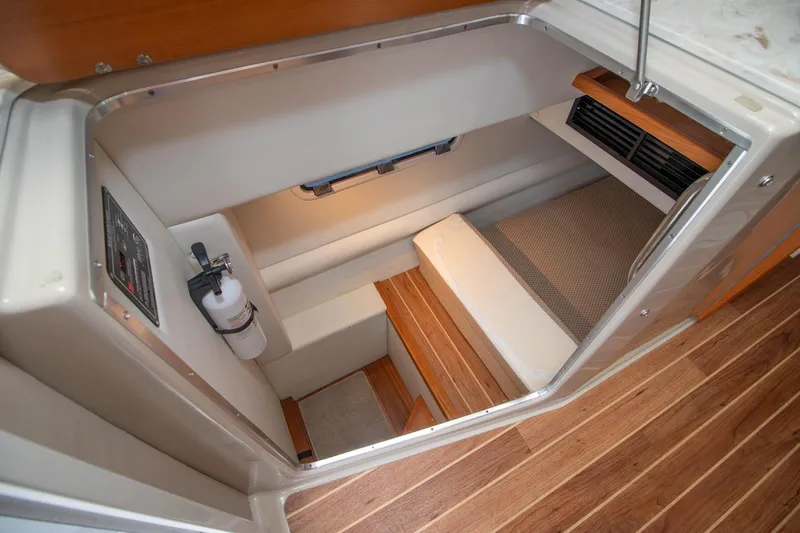  Yacht Photos Pics 2021 Aspen C108 boat interior with wooden flooring and compact cabin space.