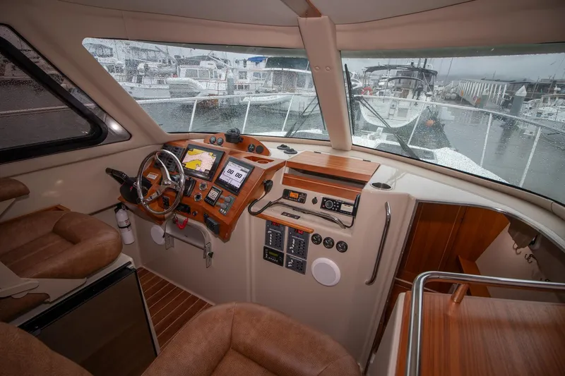  Yacht Photos Pics Interior view of 2021 Aspen C108 boat cockpit with navigation equipment and leather seating.
