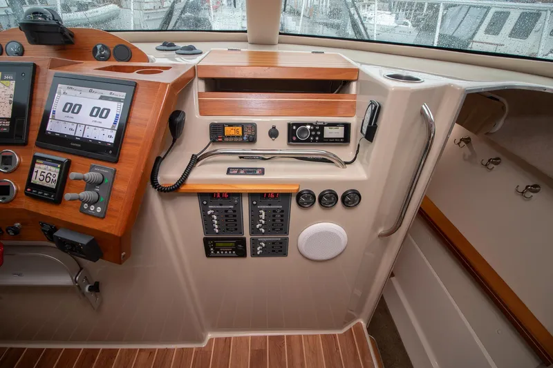  Yacht Photos Pics 2021 Aspen C108 boat dashboard with navigation screens, controls, and communication equipment.