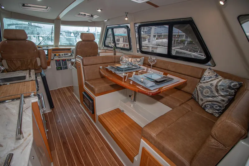  Yacht Photos Pics Luxurious interior of 2021 Aspen C108 yacht with elegant dining area and plush seating.