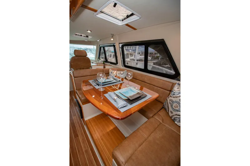  Yacht Photos Pics Luxurious interior of 2021 Aspen C108 yacht with elegant dining setup.