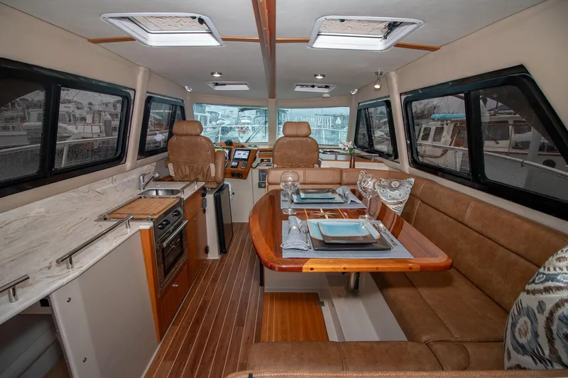  Yacht Photos Pics Luxurious 2021 Aspen C108 yacht interior with dining area and kitchen.
