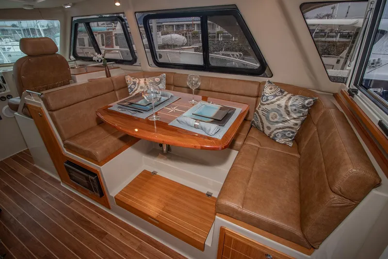  Yacht Photos Pics Luxurious interior of 2021 Aspen C108 boat with elegant dining area and plush seating.