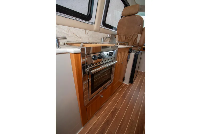  Yacht Photos Pics 2021 Aspen C108 interior kitchen with oven, sink, and wooden flooring.