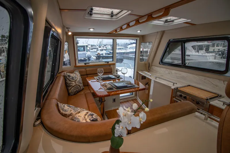  Yacht Photos Pics Luxurious interior of 2021 Aspen C108 yacht with elegant seating and dining area.