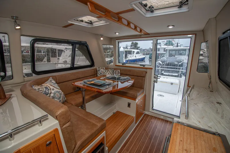  Yacht Photos Pics Luxurious interior of 2021 Aspen C108 yacht with elegant seating and dining area.