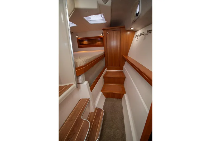  Yacht Photos Pics 2021 Aspen C108 boat interior with wooden steps and cozy cabin space.