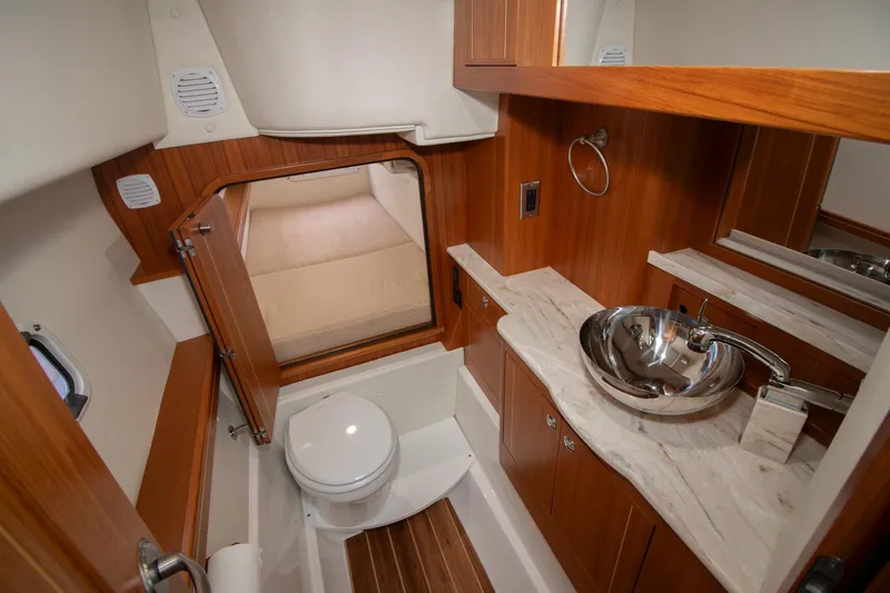  Yacht Photos Pics Luxurious 2021 Aspen C108 yacht bathroom with wood accents and modern fixtures.