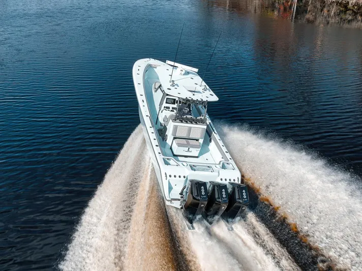 One Time Yacht Photos Pics 2024 Front Runner 36 Center Console boat speeding on water, showcasing powerful engines.