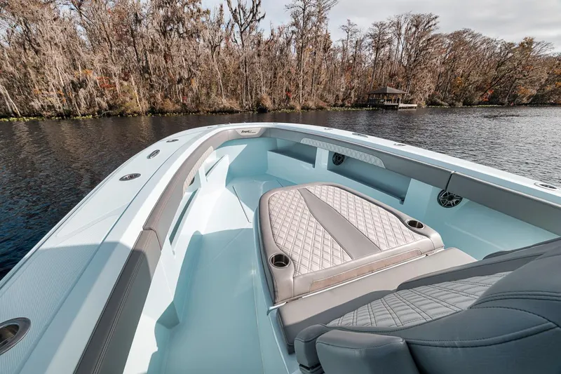 One Time Yacht Photos Pics 2024 Front Runner 36 Center Console boat on a serene lake with forested shoreline.
