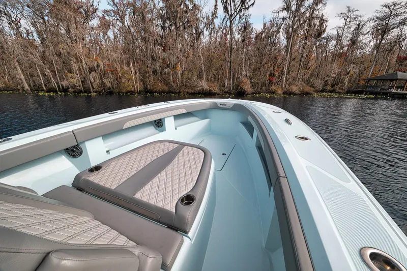 One Time Yacht Photos Pics 2024 Front Runner 36 Center Console boat on a serene lake with forest backdrop.