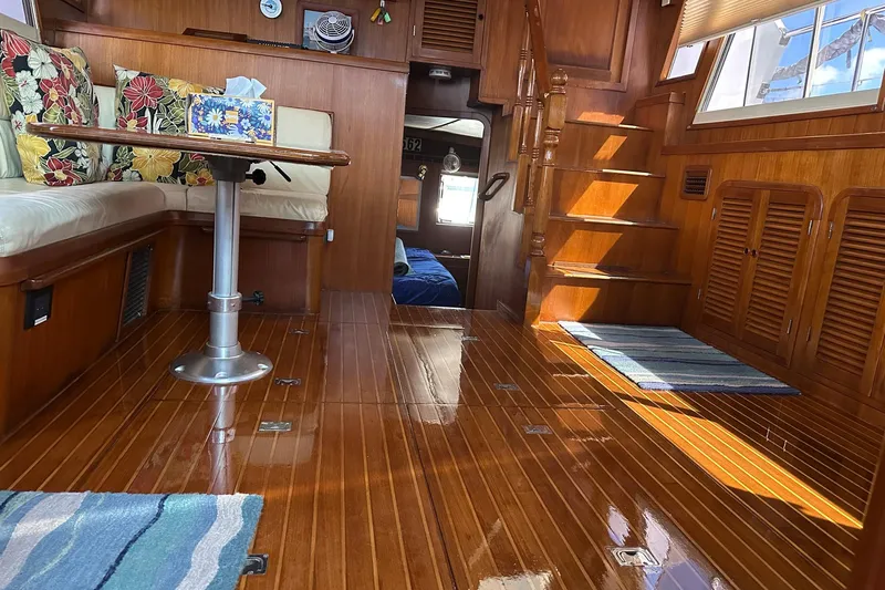 Off Ramp Yacht Photos Pics Luxurious 2002 Novatec Sundeck interior with polished wood flooring and cozy seating area.