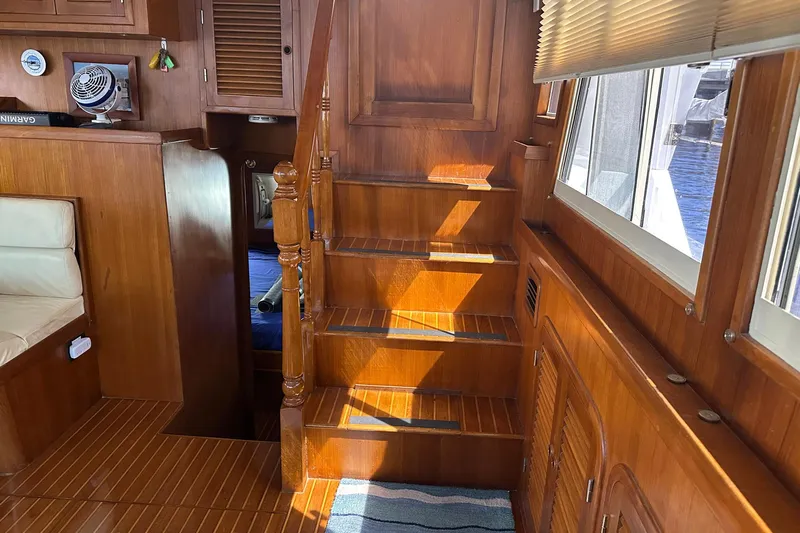 Off Ramp Yacht Photos Pics Interior of 2002 Novatec Sundeck yacht with wooden stairs and seating area.