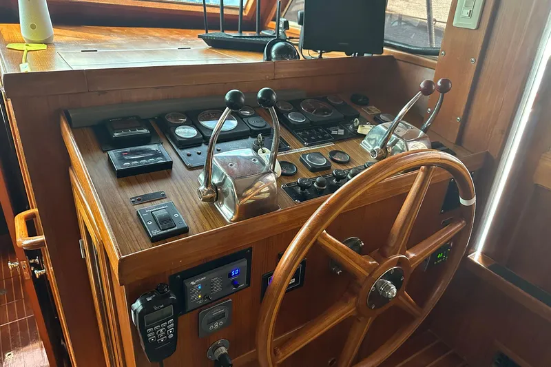 Off Ramp Yacht Photos Pics Novatec Sundeck 2002 yacht helm with wooden wheel and control panel.