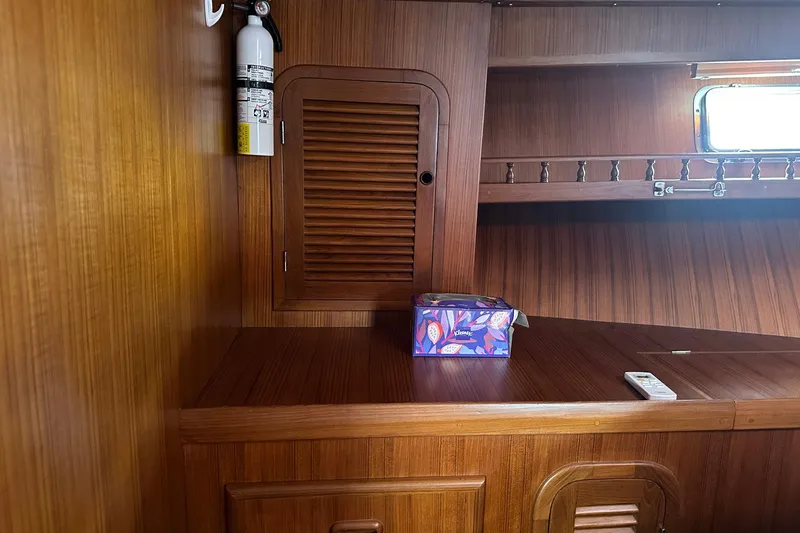 Off Ramp Yacht Photos Pics 2002 Novatec Sundeck interior with wooden cabinetry, fire extinguisher, and tissue box.