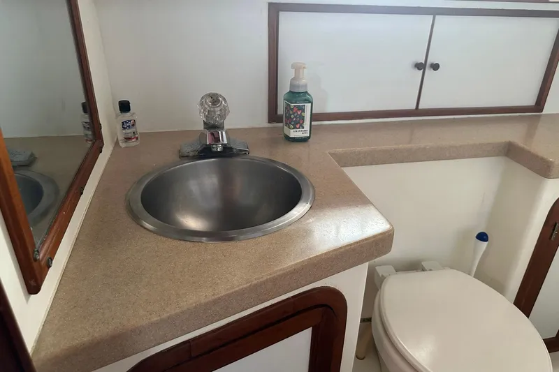 Off Ramp Yacht Photos Pics Novatec Sundeck 2002 yacht bathroom with sink, mirror, and toiletries.