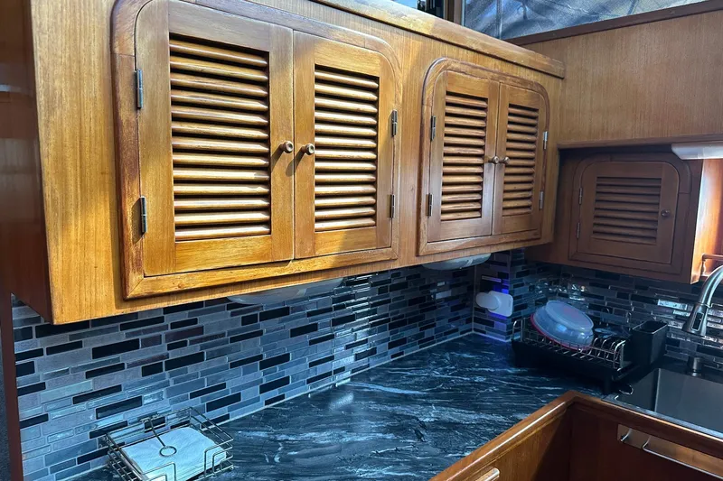 Off Ramp Yacht Photos Pics Wooden cabinets and modern backsplash in 2002 Novatec Sundeck kitchen area.