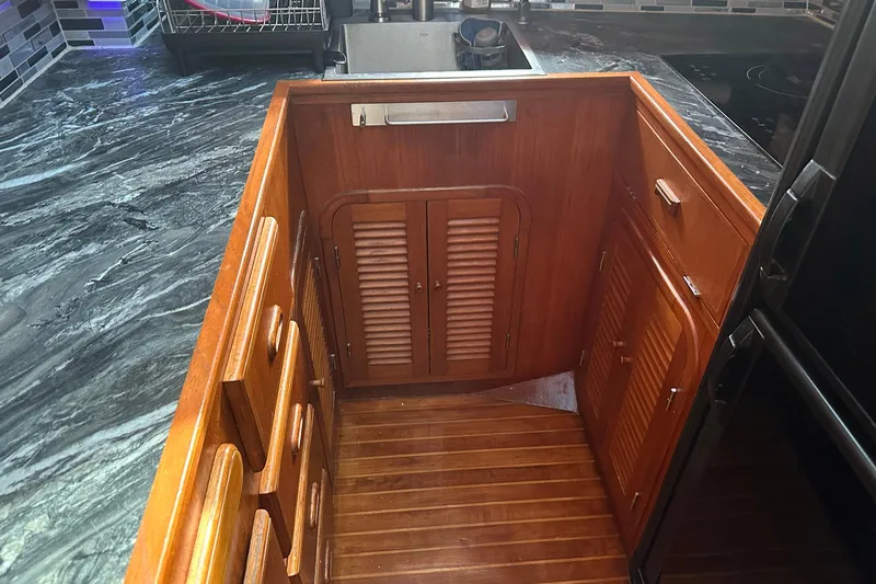 Off Ramp Yacht Photos Pics Wooden interior of 2002 Novatec Sundeck yacht with cabinets and drawers.