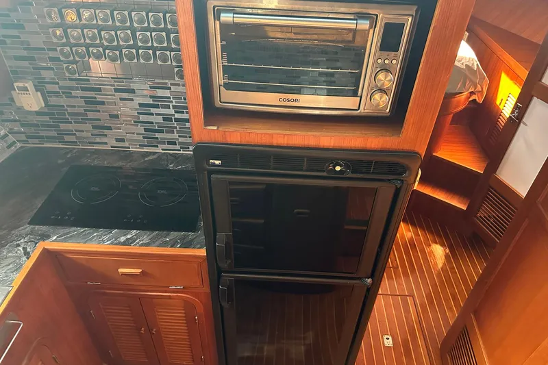 Off Ramp Yacht Photos Pics Novatec Sundeck 2002 yacht kitchen with modern appliances and wood finish.
