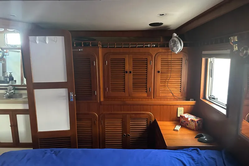 Off Ramp Yacht Photos Pics Cozy cabin interior of 2002 Novatec Sundeck yacht with wooden cabinets and window.