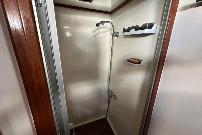 Off Ramp Yacht Photos Pics Shower area in 2002 Novatec Sundeck yacht with wooden accents and modern fixtures.