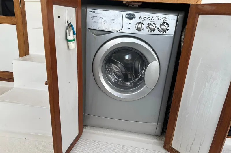 Off Ramp Yacht Photos Pics Washing machine in a 2002 Novatec Sundeck boat, enclosed in a wooden cabinet.