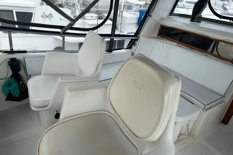 Off Ramp Yacht Photos Pics Interior of a 2002 Novatec Sundeck yacht with white seating and windows.