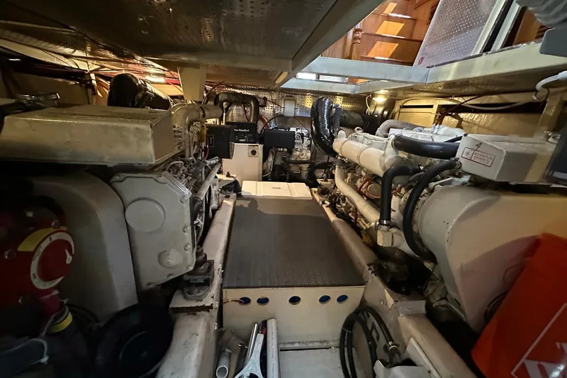 Off Ramp Yacht Photos Pics Engine room of a 2002 Novatec Sundeck yacht, showcasing dual engines and mechanical components.