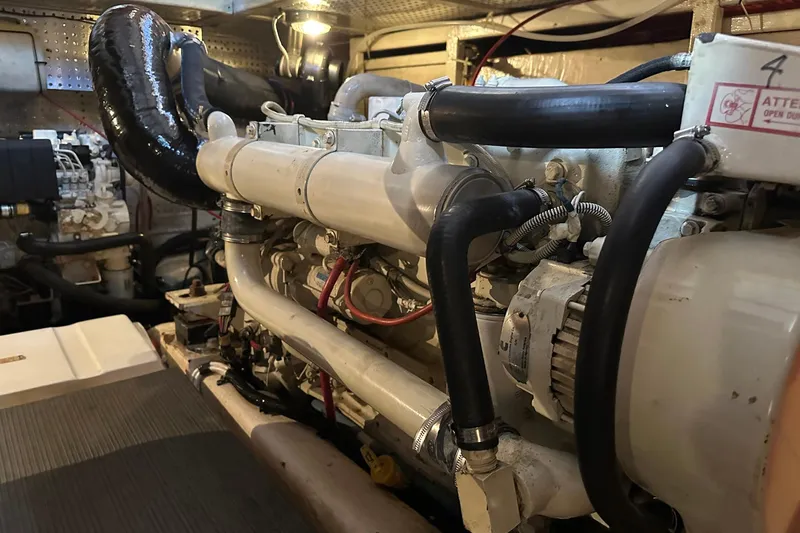 Off Ramp Yacht Photos Pics Engine room of a 2002 Novatec Sundeck yacht, showcasing mechanical components and piping.