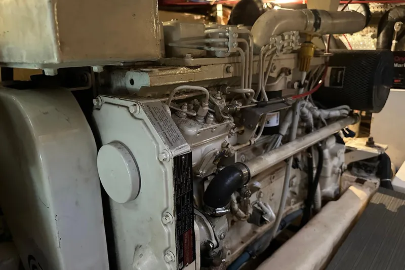 Off Ramp Yacht Photos Pics Engine of a 2002 Novatec Sundeck boat, showcasing mechanical components and piping.