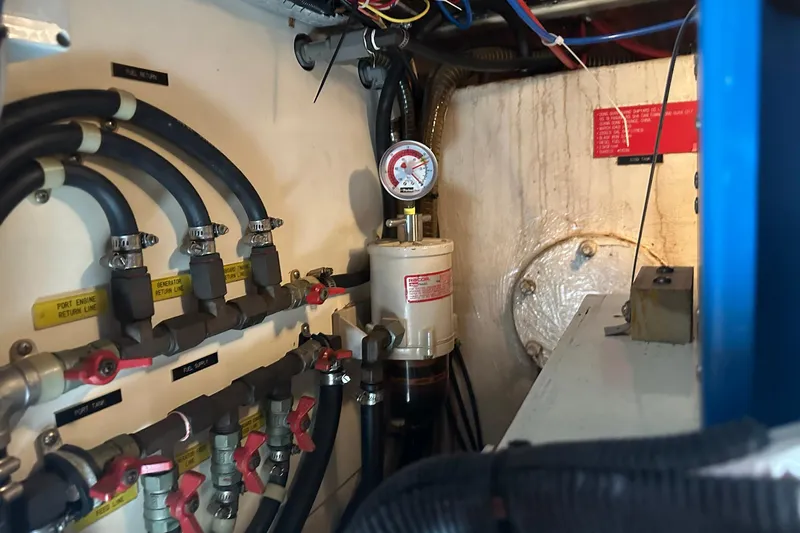 Off Ramp Yacht Photos Pics Engine room of 2002 Novatec Sundeck yacht with fuel lines and pressure gauge.