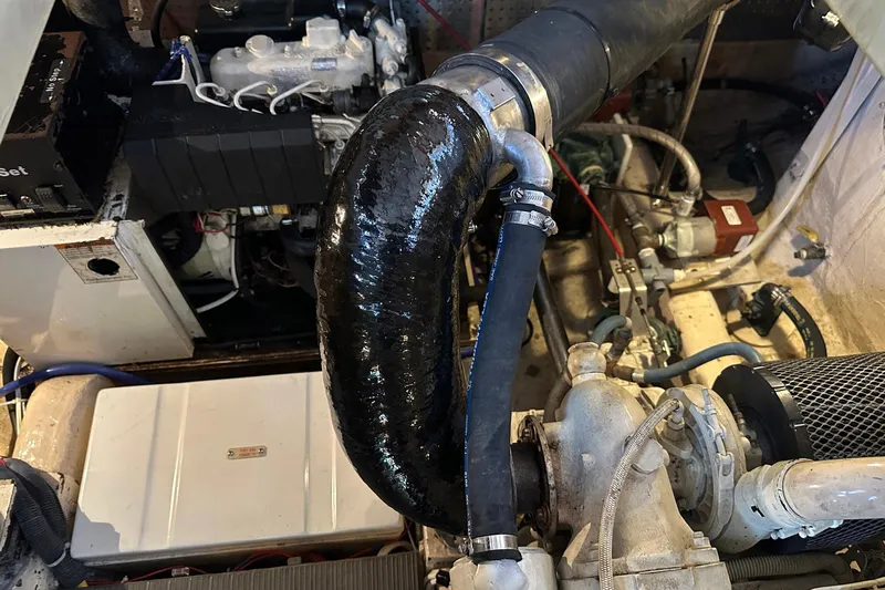 Off Ramp Yacht Photos Pics Engine room of 2002 Novatec Sundeck boat with visible components and hoses.