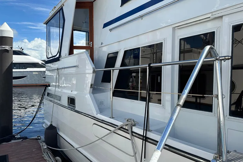 Off Ramp Yacht Photos Pics 2002 Novatec Sundeck yacht docked at marina, featuring sleek white exterior and modern design.