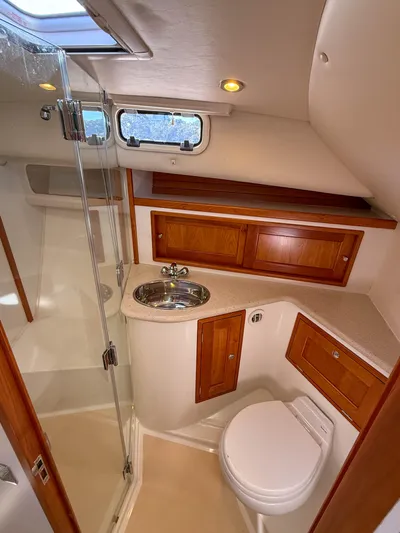 Wild Rose Yacht Photos Pics 2015 MJM 36z Downeast yacht bathroom with wood cabinetry and modern fixtures.