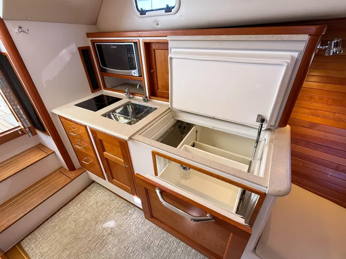 Wild Rose Yacht Photos Pics 2015 MJM 36z Downeast yacht kitchen with sink, microwave, and open fridge.