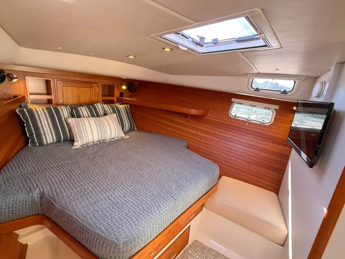 Wild Rose Yacht Photos Pics Luxurious cabin interior of 2015 MJM 36z Downeast yacht with cozy bedding and wood paneling.