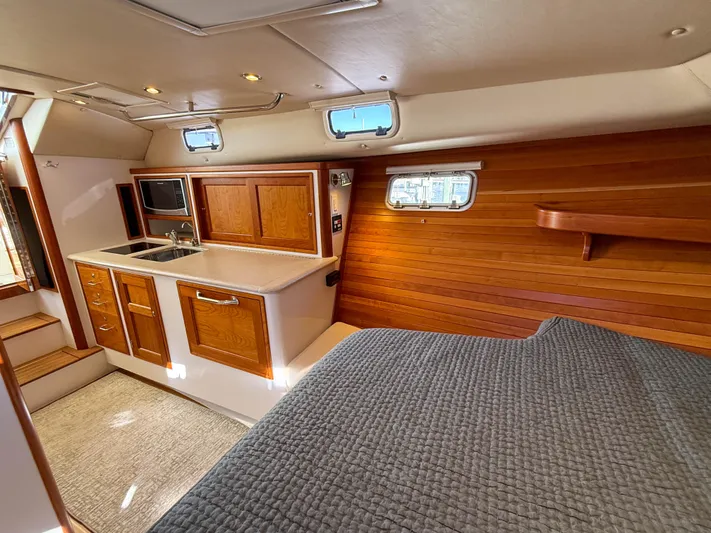 Wild Rose Yacht Photos Pics Interior of 2015 MJM 36z Downeast yacht with wood paneling and kitchenette.