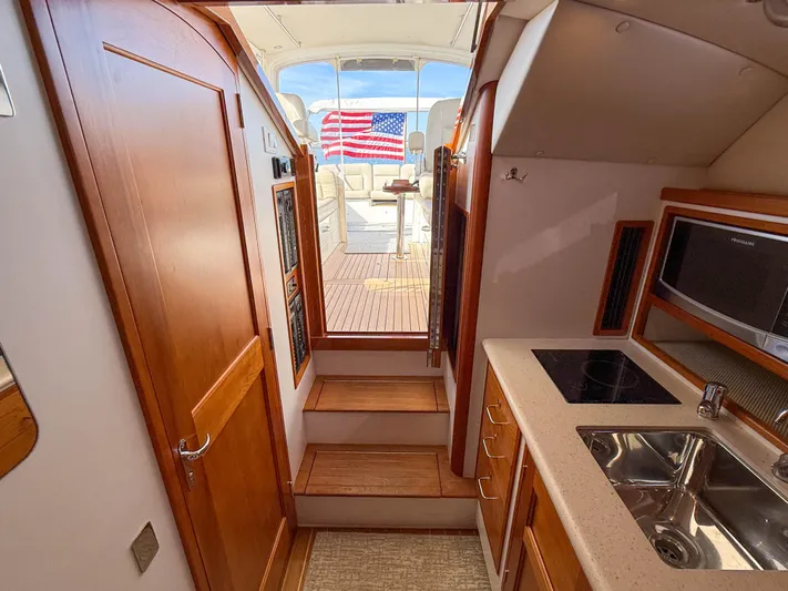 Wild Rose Yacht Photos Pics Interior of 2015 MJM 36z Downeast yacht with kitchenette and American flag view.