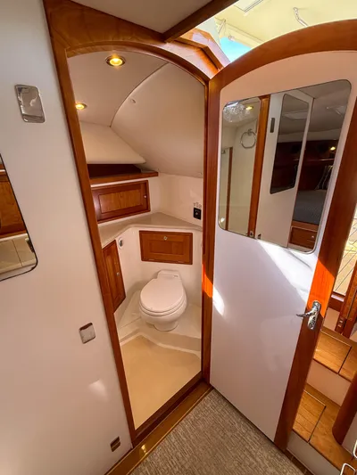 Wild Rose Yacht Photos Pics 2015 MJM 36z Downeast yacht bathroom with wooden cabinetry and modern fixtures.