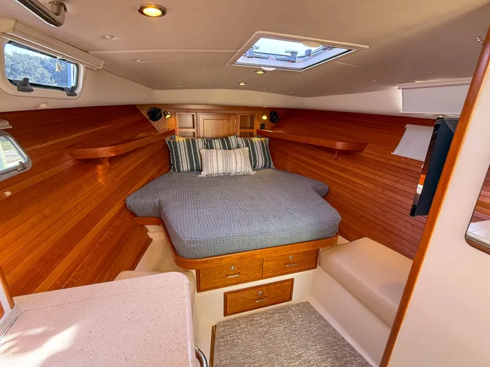 Wild Rose Yacht Photos Pics Luxurious cabin interior of 2015 MJM 36z Downeast yacht with cozy bed and wood paneling.