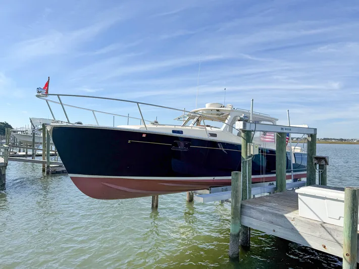 Wild Rose Yacht Photos Pics 2015 MJM 36z Downeast boat docked on a lift by the water.