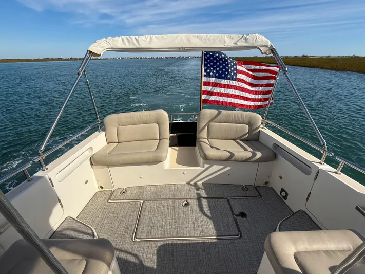 Wild Rose Yacht Photos Pics 2015 MJM 36z Downeast boat interior with American flag, cruising on calm waters.