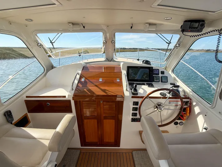 Wild Rose Yacht Photos Pics 2015 MJM 36z Downeast boat interior with steering wheel and navigation equipment.
